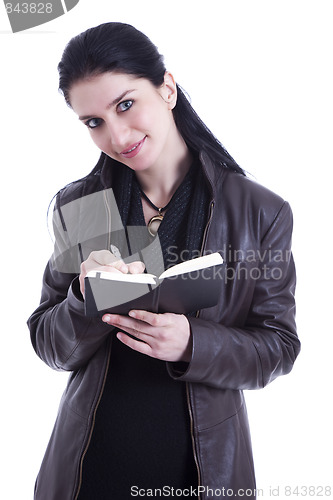 Image of beautiful businesswoman taking notes