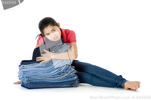 Image of woman with lots of jeans