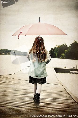 Image of girl with umbrella on the bridge