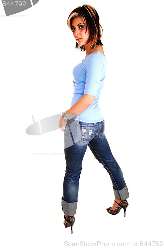 Image of Young woman standing and looking back.