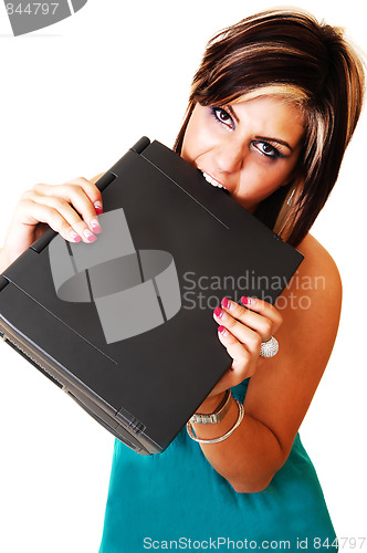 Image of A young girl angry bite at her laptop.