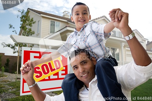 Image of Hispanic Father and Son in Front of Their New Home