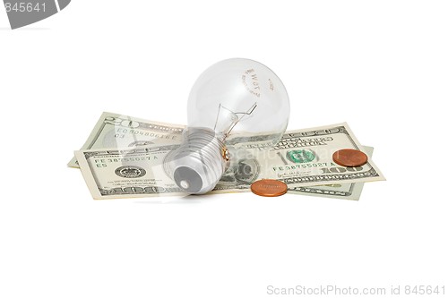 Image of Electric bulb on dollar bills with cents isolated