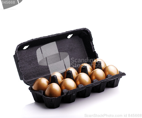 Image of Gold eggs in a black carton