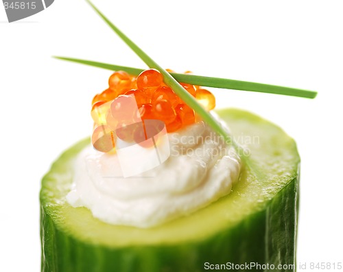 Image of Appetizer with red caviar and a cucumber