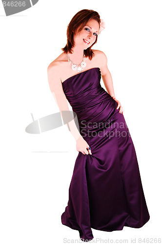 Image of Young pretty girl standing in burgundy evening dress.