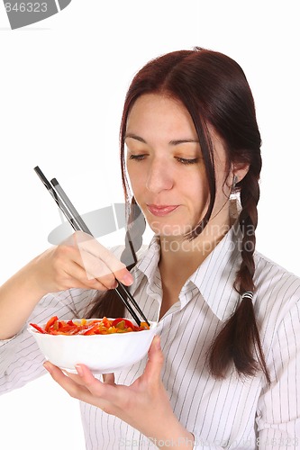 Image of Beautiful woman eating with chopsticks
