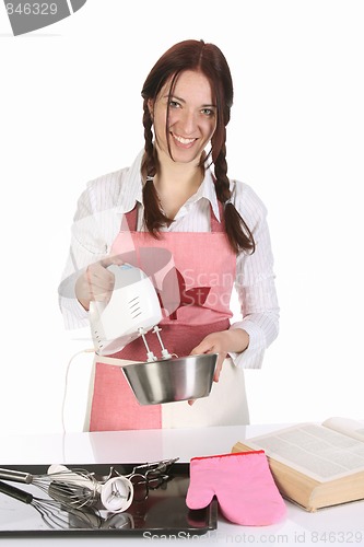 Image of beautiful housewife preparing with kitchen mixer