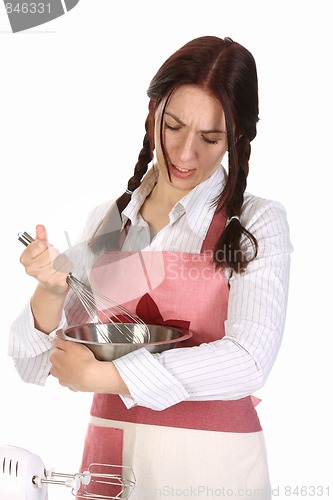 Image of tired housewife preparing with egg beater