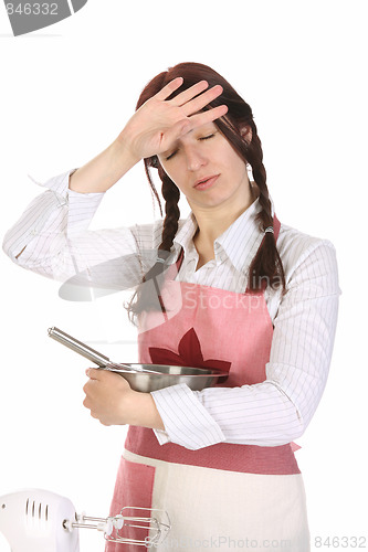 Image of tired housewife preparing with egg beater