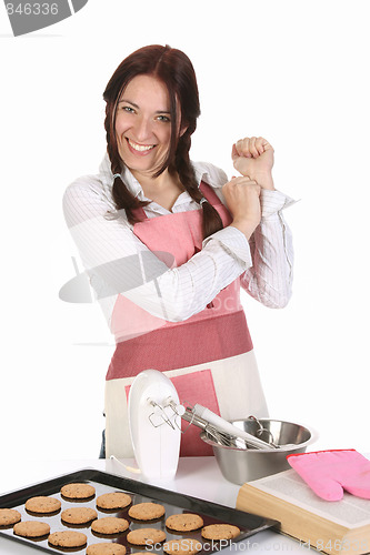 Image of beautiful housewife with completed cakes