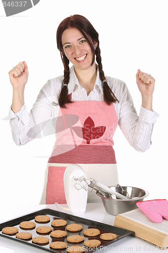 Image of beautiful housewife with completed cakes