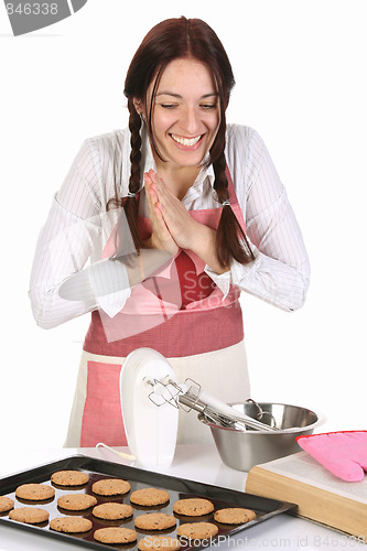 Image of beautiful housewife with completed cakes