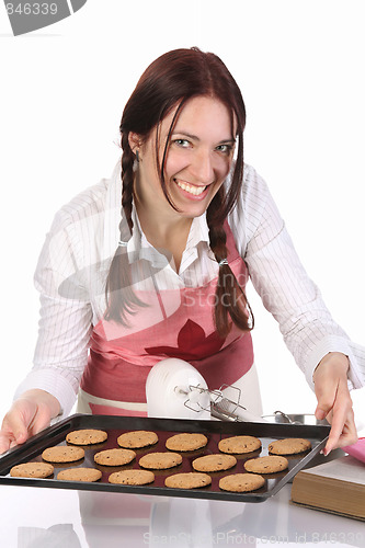 Image of beautiful housewife showing off cakes