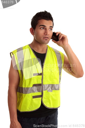 Image of Builder tradesman takes a call