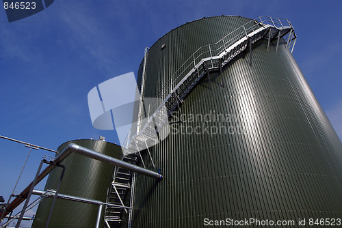 Image of Low-angle shot of ladder and tanks refinery