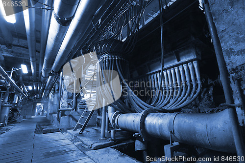 Image of Pipes, tubes, machinery and steam turbine at a power plant