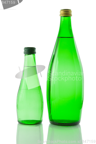 Image of Bottles  of mineral water reflected on white background