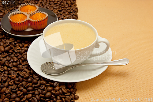 Image of White cup of coffee and coffee beans