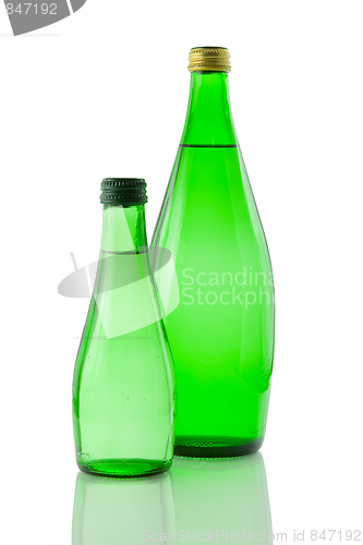 Image of Bottles  of mineral water reflected on white background