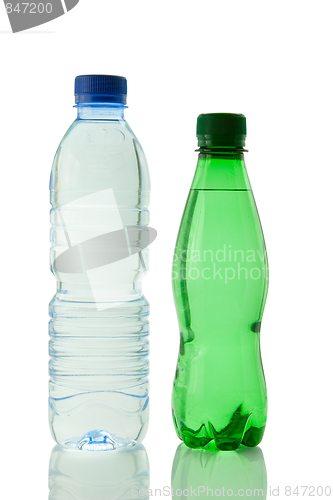 Image of Bottles  of mineral water reflected on white background