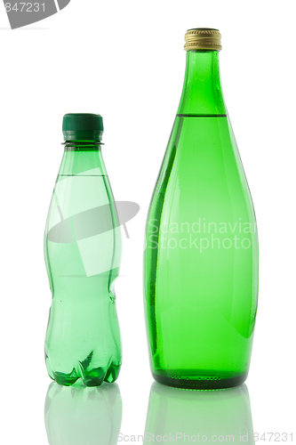 Image of Bottles  of mineral water reflected on white background