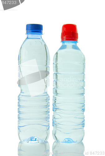 Image of Bottles  of mineral water reflected on white background