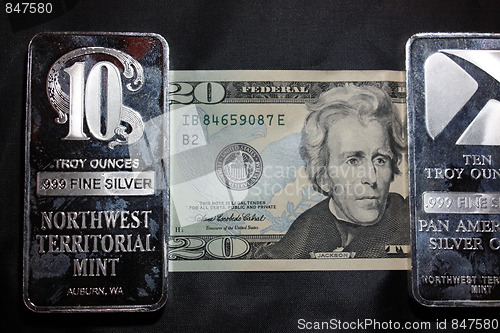 Image of American money and silver bullion.