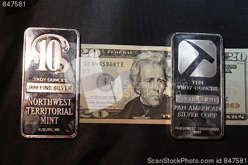 Image of American money and silver bullion.