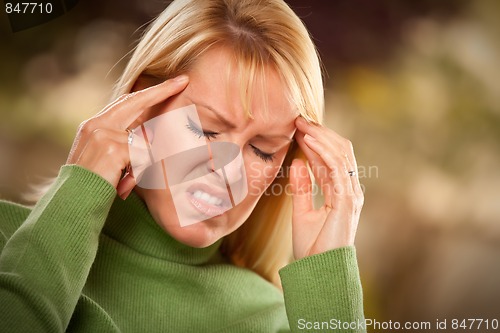 Image of Grimacing Woman Suffering a Headache