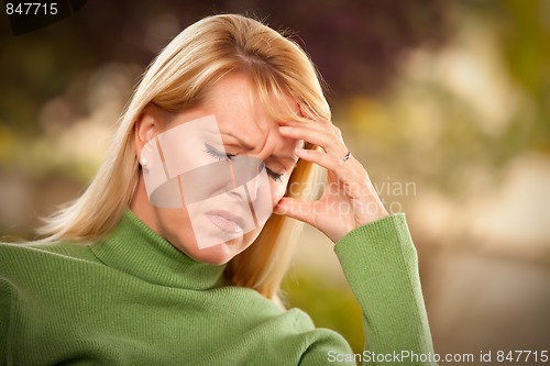 Image of Grimacing Woman Suffering a Headache or Sorrow