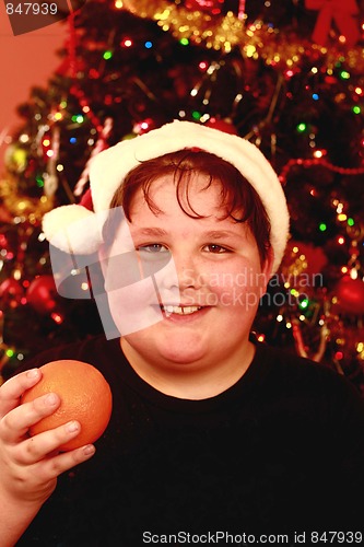 Image of Young boy at Christmas with santa hat