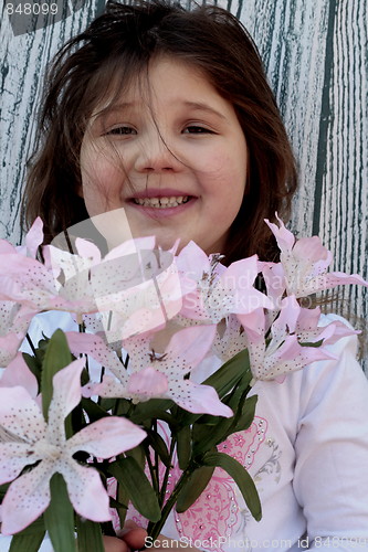 Image of Little girl with bouquet of flowers