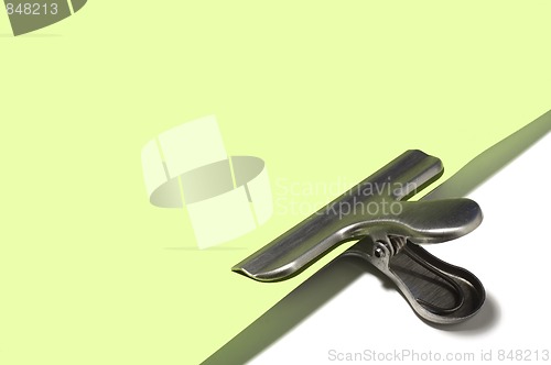 Image of Metallic paperclip on green paper