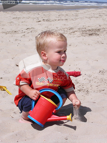 Image of Little boy playing on the beach
