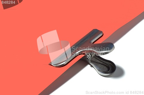 Image of Metallic paperclip on red paper