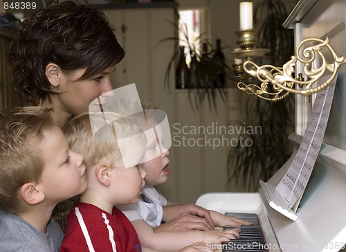 Image of Family playing piano