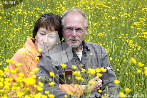 Image of Senior couple in a buttercup field