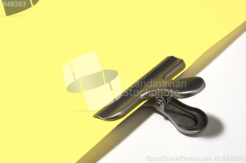 Image of Metallic paperclip on yellow paper