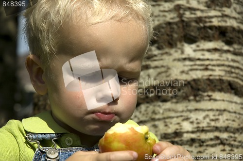Image of Little boy with juicy apple