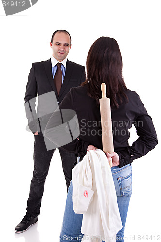 Image of woman waiting for her husband, with the rolling pin and a white shirt with lipstick mark hidden behind his back