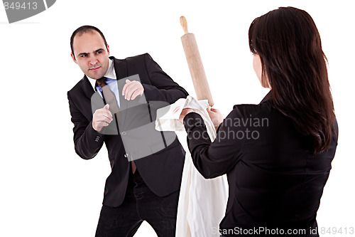 Image of woman arguing with her husband, pointing to the rolling pin and a shirt with lipstick mark