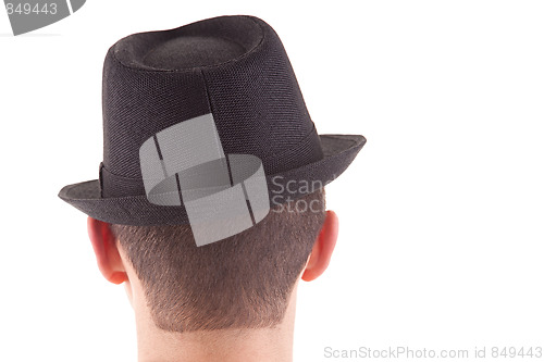 Image of man on his back with a black hat on