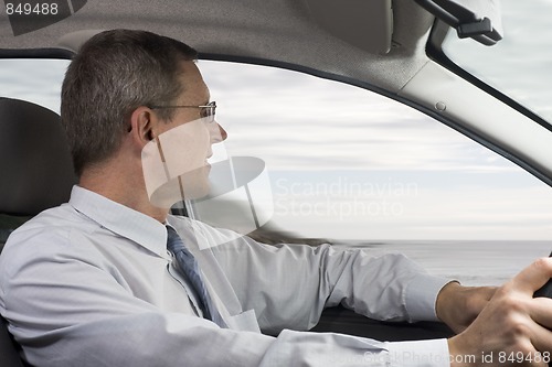 Image of Businessman driving a car