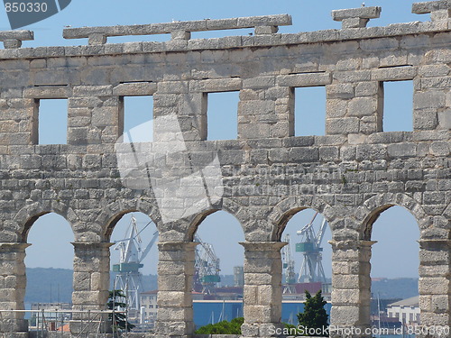Image of Croatia. Istria. Pula. Seaport cranes through windows of the Arena of Pula  