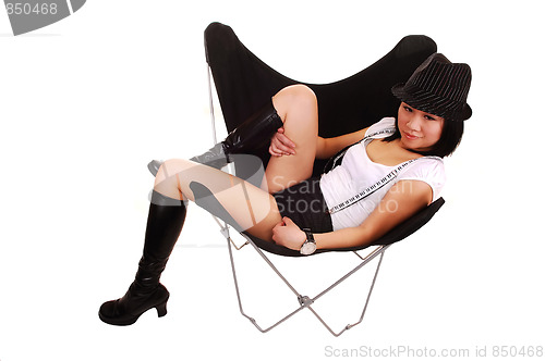 Image of Asian girl lying in a butterfly chair.