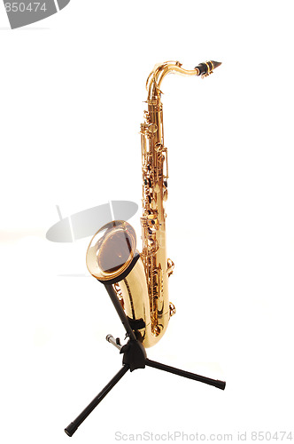 Image of An brass saxophone on the stand.