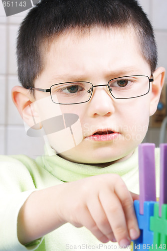 Image of Boy playing with toy blocks
