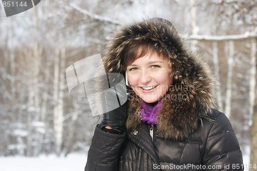 Image of Positive woman on cellphone in frosty day
