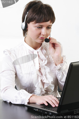 Image of Businesswoman with headset working at computer